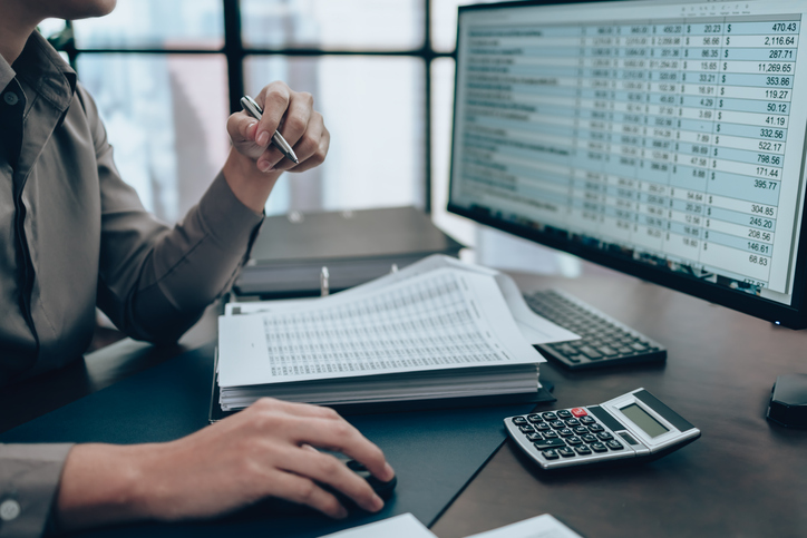 A man is calculating taxes to optimize the accounting process for the growth of the business.