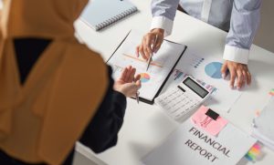 Two people reviewing charts for end-of-year financial reporting.