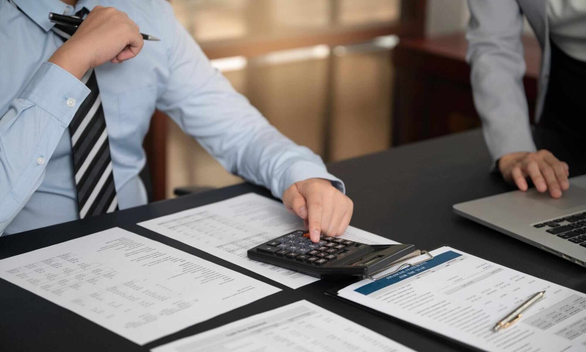 Business professionals reviewing financial documents during a business succession planning Canada strategy meeting.