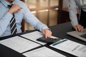 Business professionals reviewing financial documents during a business succession planning Canada strategy meeting.
