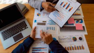 Business professionals reviewing financial reports and performance charts during an audit services Canada engagement focused on financial reporting and business assurance.