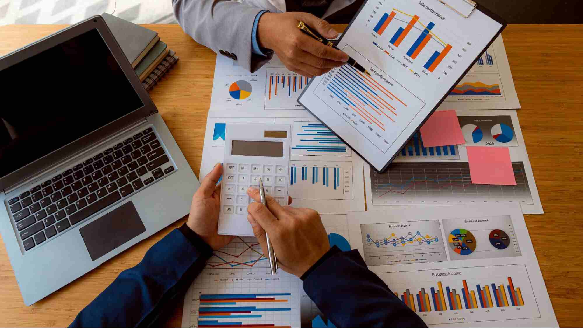 Business professionals reviewing financial reports and performance charts during an audit services Canada engagement focused on financial reporting and business assurance.
